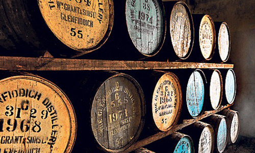 whisky barrels ageing in warehouse